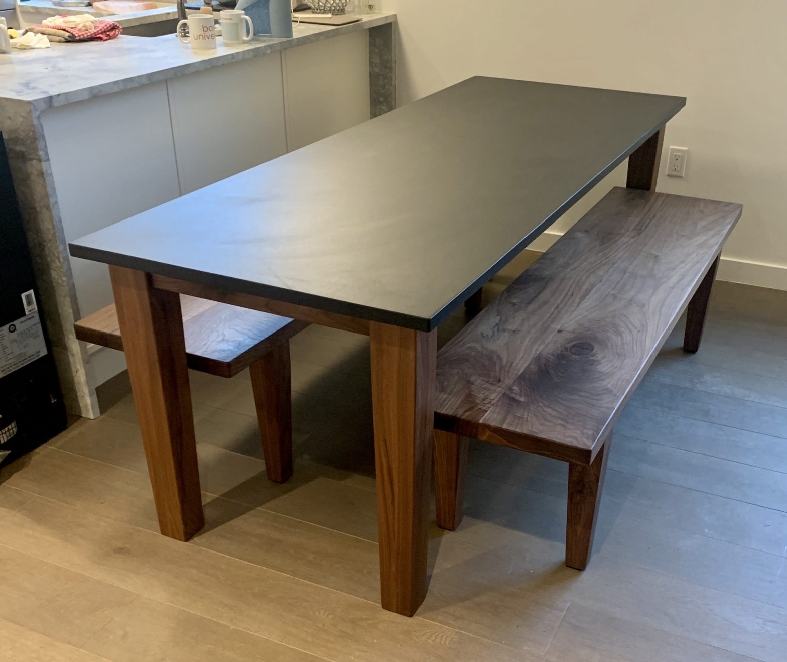 Custom Black Walnut table with benches and custom Churchill Soapstone table top