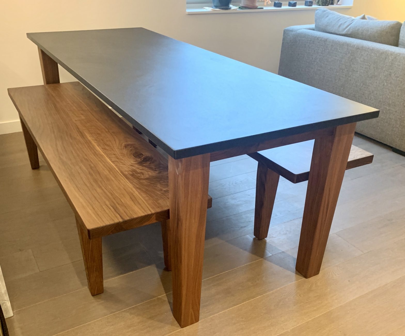 Custom Black Walnut table with benches and custom Churchill Soapstone table top