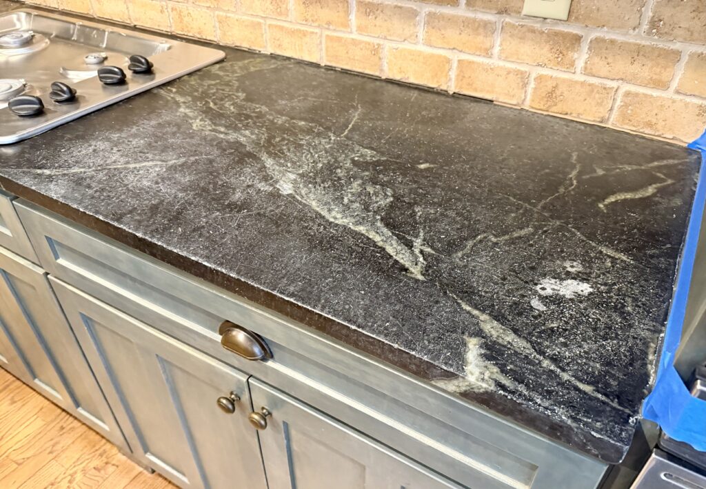 Pre-sanding soapstone slab showing natural wear in Westfield